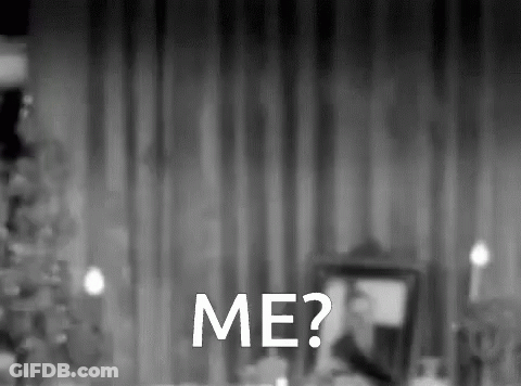 A Black And White Photo Of A Man Sitting At A Table With The Words Me Written In White GIF