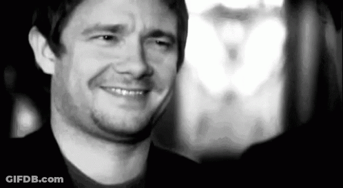 A Black And White Photo Of A Man Smiling And Making A Face . GIF