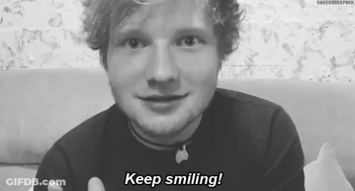 A Black And White Photo Of A Man Smiling With The Words Keep Smiling Written Below Him . GIF