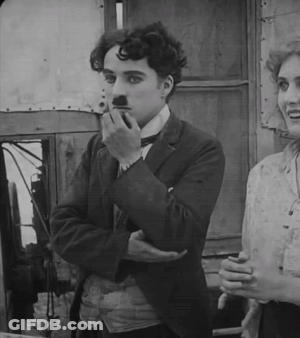 A Black And White Photo Of A Man Smoking A Cigarette And A Woman Smiling GIF