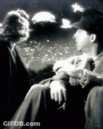 A Black And White Photo Of A Man Smoking A Cigarette With The Date 10 2022 GIF