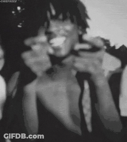 A Black And White Photo Of A Man Smoking A Cigarette With The Name Chiefkeef At The Bottom GIF