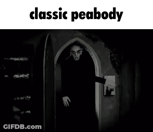 A Black And White Photo Of A Man Standing In A Doorway With The Caption Classic Peabody GIF