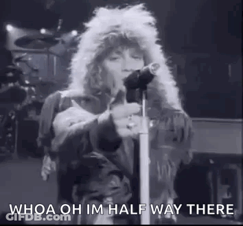 A Black And White Photo Of A Man Standing In Front Of A Microphone . GIF