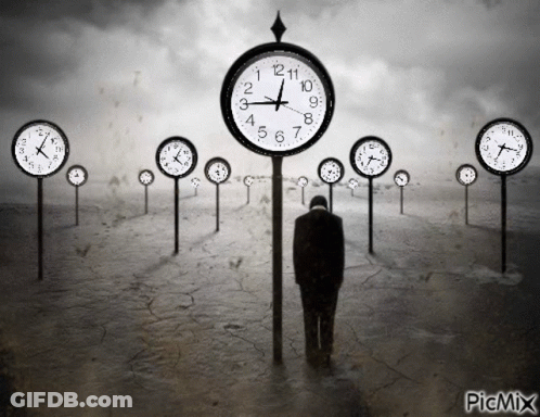 A Black And White Photo Of A Man Standing In Front Of A Row Of Clocks That Says Picmix At The Bottom GIF