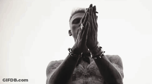 A Black And White Photo Of A Man Standing In Front Of A Window With His Hands In The Air . GIF