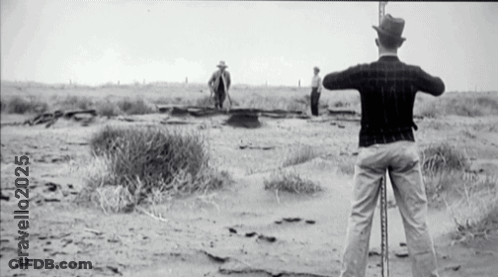 A Black And White Photo Of A Man Standing In The Desert With The Year 2025 GIF