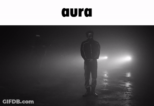A Black And White Photo Of A Man Standing In The Fog With The Word Aura Above Him GIF
