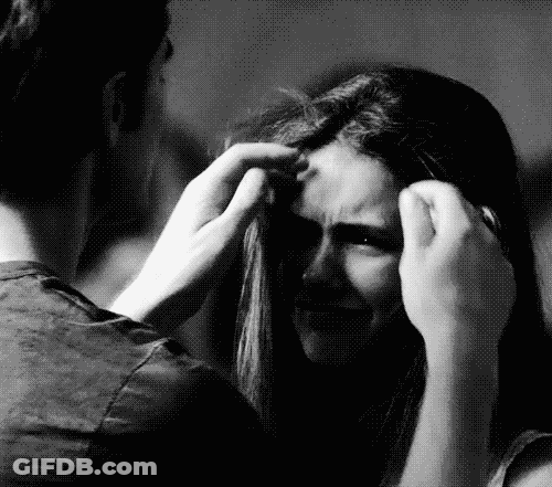 A Black And White Photo Of A Man Touching A Woman 'S Head . GIF