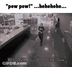 A Black And White Photo Of A Man Walking Down A Hallway GIF