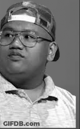 A Black And White Photo Of A Man Wearing A Baseball Cap And Glasses . GIF