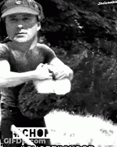 A Black And White Photo Of A Man Wearing A Baseball Cap And Holding A Bat With The Word Chop On The Bottom GIF