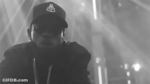 A Black And White Photo Of A Man Wearing A Baseball Cap GIF
