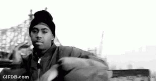 A Black And White Photo Of A Man Wearing A Beanie And Jacket . GIF