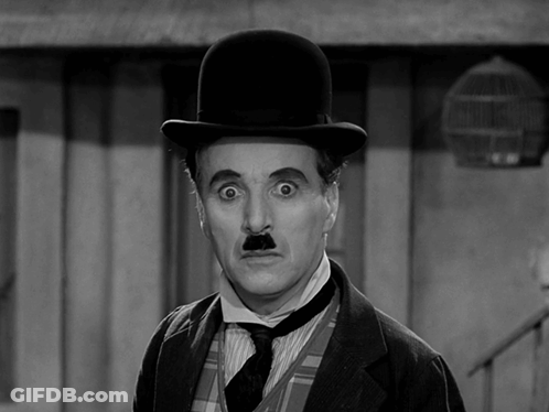 A Black And White Photo Of A Man Wearing A Bowler Hat GIF
