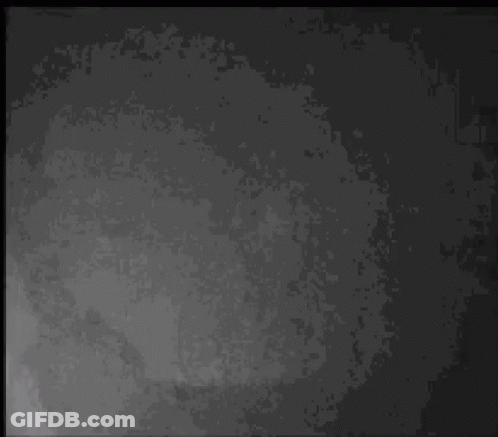 A Black And White Photo Of A Man Wearing A Cowboy Hat Talking On A Cell Phone . GIF