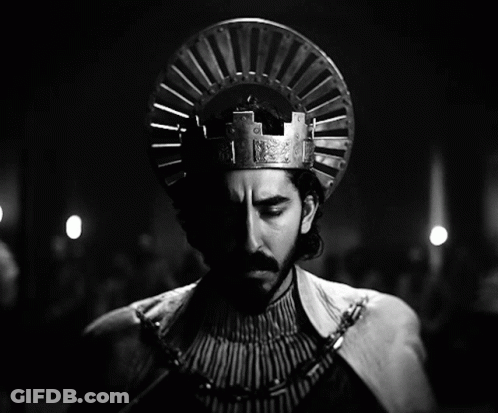A Black And White Photo Of A Man Wearing A Crown On His Head GIF