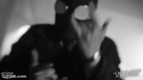 A Black And White Photo Of A Man Wearing A Gas Mask And Goggles . GIF