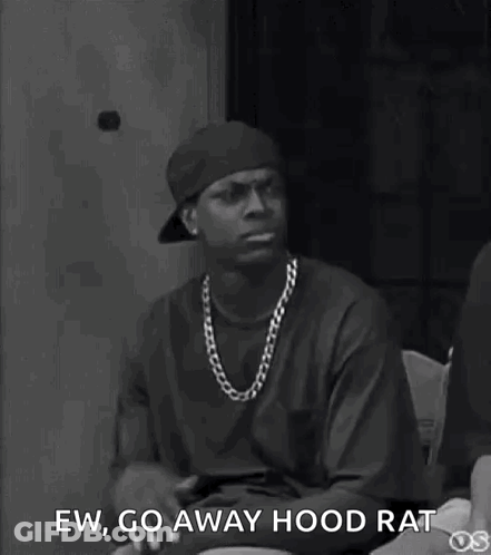 A Black And White Photo Of A Man Wearing A Hat And A Necklace . GIF