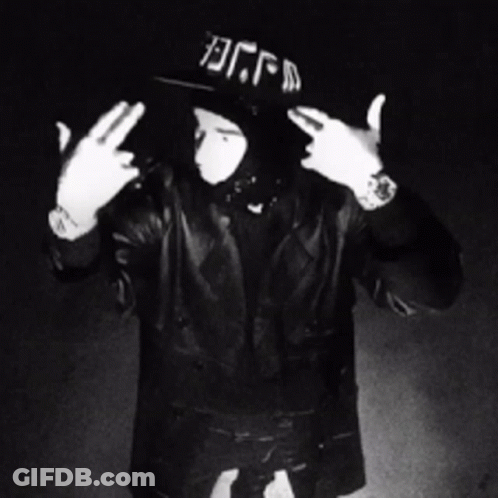 A Black And White Photo Of A Man Wearing A Hat That Says Dfm GIF