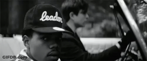 A Black And White Photo Of A Man Wearing A Hat That Says Leader GIF