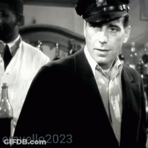 A Black And White Photo Of A Man Wearing A Hat With The Year 2023 On The Bottom GIF