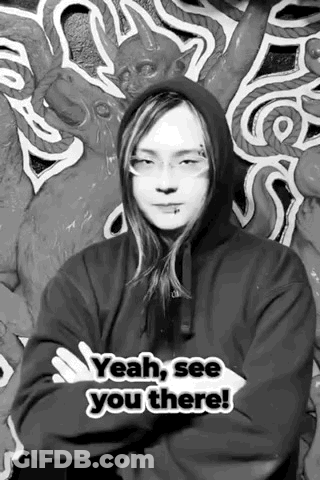A Black And White Photo Of A Man Wearing A Hoodie And Glasses . GIF