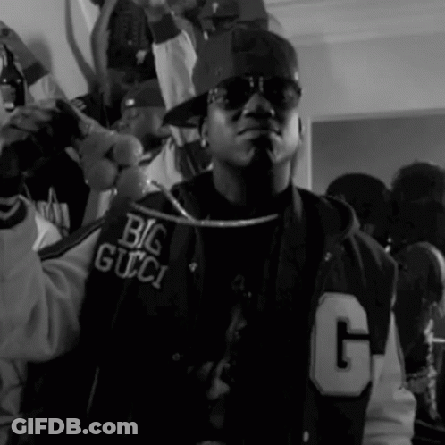 A Black And White Photo Of A Man Wearing A Jacket That Says Big Gucci GIF