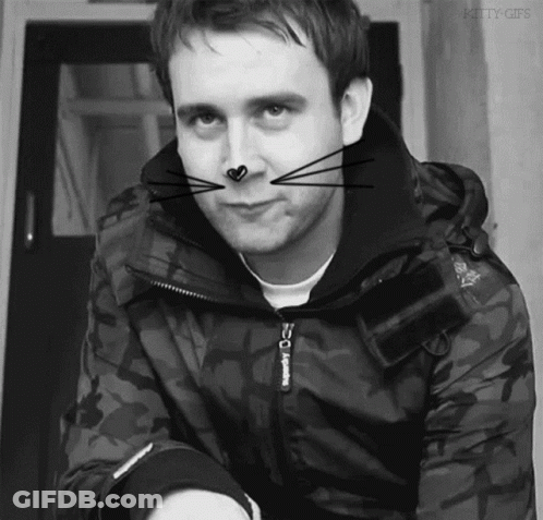 A Black And White Photo Of A Man Wearing A Jacket With The Word Superdry On It GIF