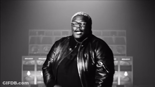 A Black And White Photo Of A Man Wearing A Leather Jacket And Glasses GIF