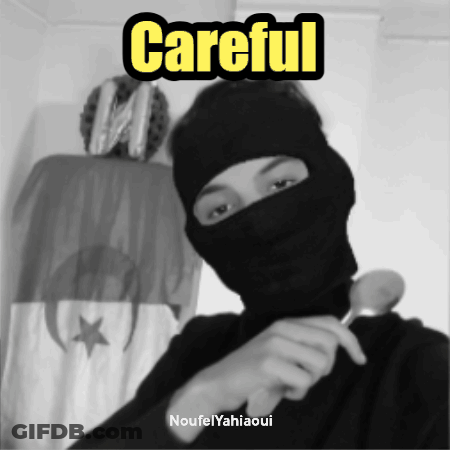 A Black And White Photo Of A Man Wearing A Mask With The Words Careful Written Above Him GIF