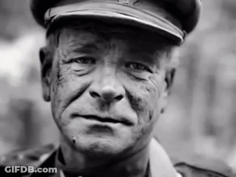 A Black And White Photo Of A Man Wearing A Military Uniform GIF