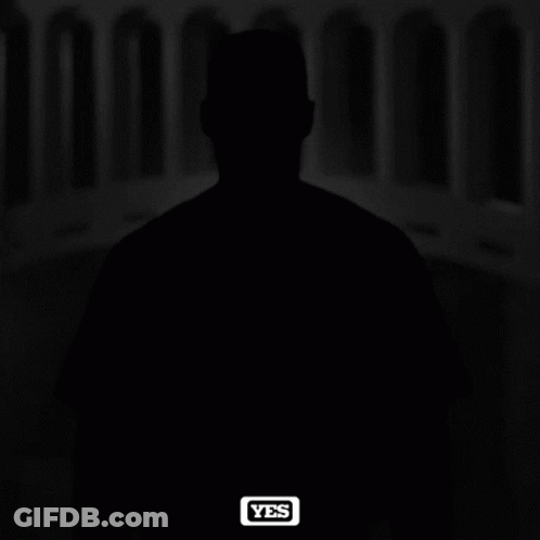 A Black And White Photo Of A Man Wearing A Ny Yankees Hat GIF