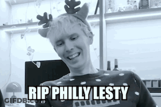 A Black And White Photo Of A Man Wearing A Reindeer Headband . GIF