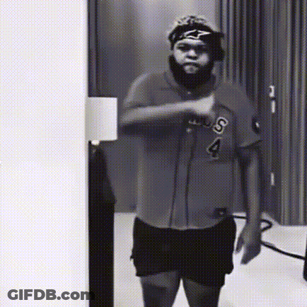 A Black And White Photo Of A Man Wearing A Shirt With The Letter S On It GIF