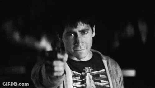 A Black And White Photo Of A Man Wearing A Skeleton Shirt Giving The Middle Finger . GIF