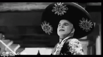 A Black And White Photo Of A Man Wearing A Sombrero And A Suit . GIF