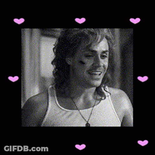 A Black And White Photo Of A Man Wearing A Tank Top With Pink Hearts Around Him GIF