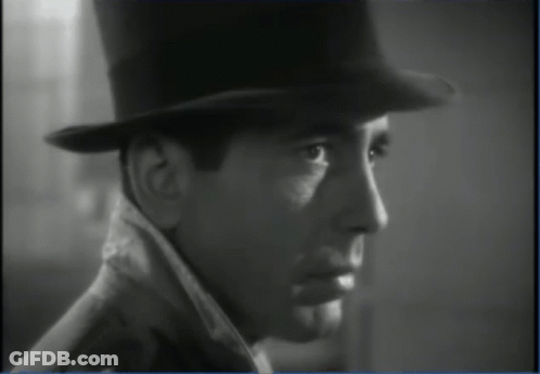 A Black And White Photo Of A Man Wearing A Top Hat And Coat GIF