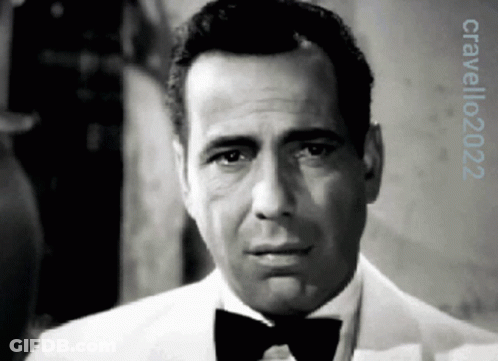 A Black And White Photo Of A Man Wearing A Tuxedo And Bow Tie With The Year 2022 On The Bottom GIF