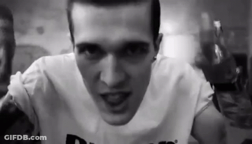 A Black And White Photo Of A Man Wearing A White Shirt . GIF