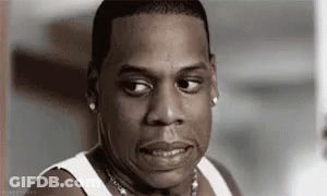 A Black And White Photo Of A Man Wearing A White Tank Top Making A Funny Face . GIF