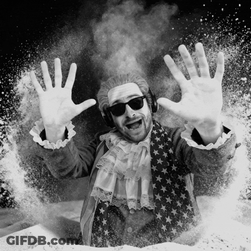 A Black And White Photo Of A Man Wearing A Wig And Sunglasses GIF