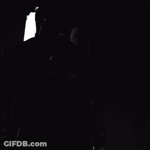 A Black And White Photo Of A Man Wearing Glasses And A Black Shirt That Says ' Bx4 ' GIF