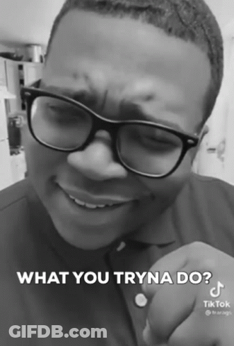 A Black And White Photo Of A Man Wearing Glasses And A Shirt That Says What You Tryna Do GIF