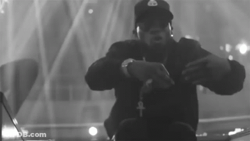 A Black And White Photo Of A Man Wearing Headphones And A Hat That Has The Letter B On It GIF