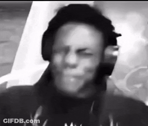 A Black And White Photo Of A Man Wearing Headphones And A Hat . GIF