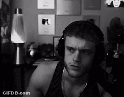 A Black And White Photo Of A Man Wearing Headphones In A Room . GIF