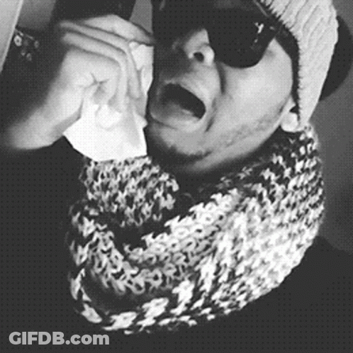 A Black And White Photo Of A Man Wearing Sunglasses And A Scarf Crying GIF