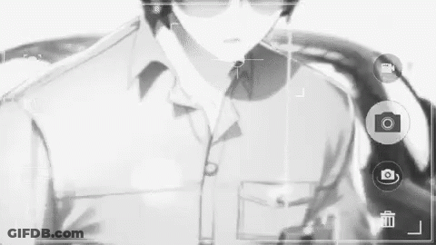 A Black And White Photo Of A Man Wearing Sunglasses And A Suit . GIF